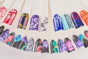 Finger nail art design samples. Beautiful nail art on plastic tips. Manicure nail color design samples.