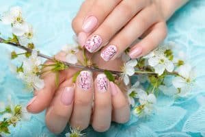 Spring manicure for the bride in gentle tones with flowers. Nail Design.